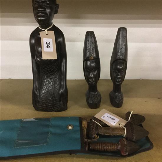 Three African carved hardwood heads & three knives in sheaths